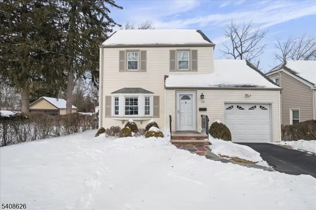 a view of a house with snow yard and sitting area