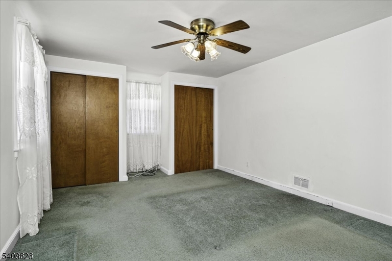 112 Union Street Cedar Grove, NJ 07009 - Photo 31 of 43 an empty room with closet and a chandelier fan