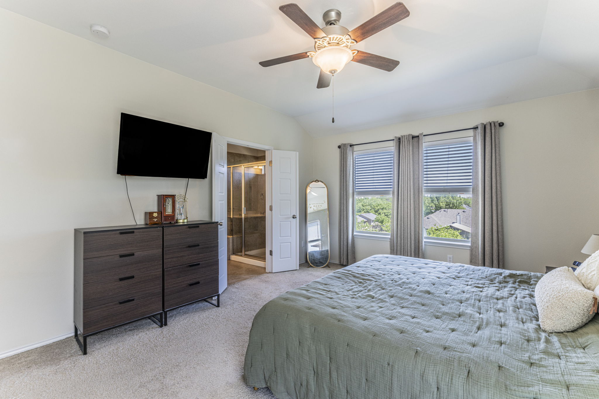 20205 Navarre Terrace Pflugerville, TX 78660 - Photo 11 of 24 a bedroom with a bed and a flat screen tv
