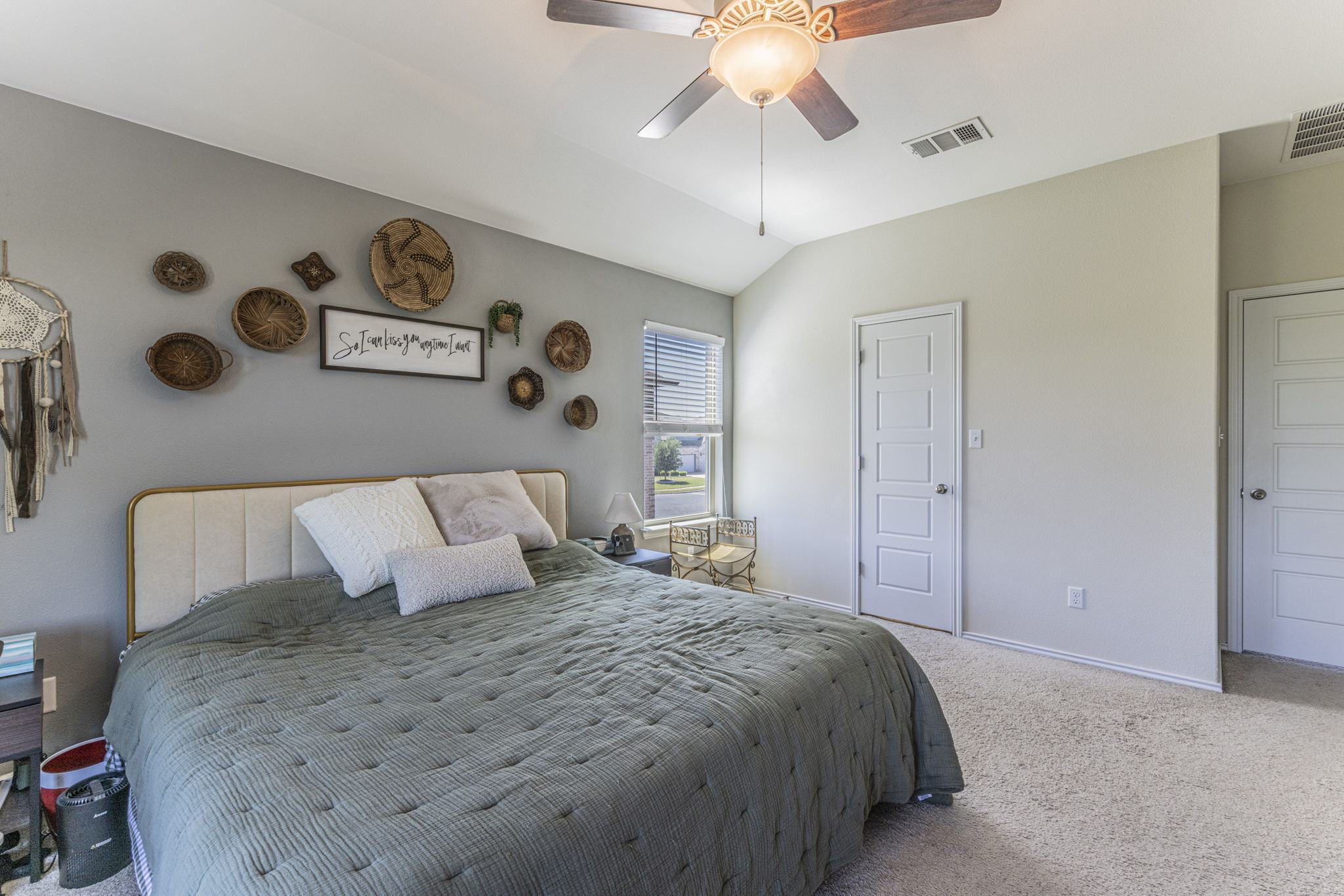 20205 Navarre Terrace Pflugerville, TX 78660 - Photo 12 of 24 a bedroom with a large bed and a chandelier