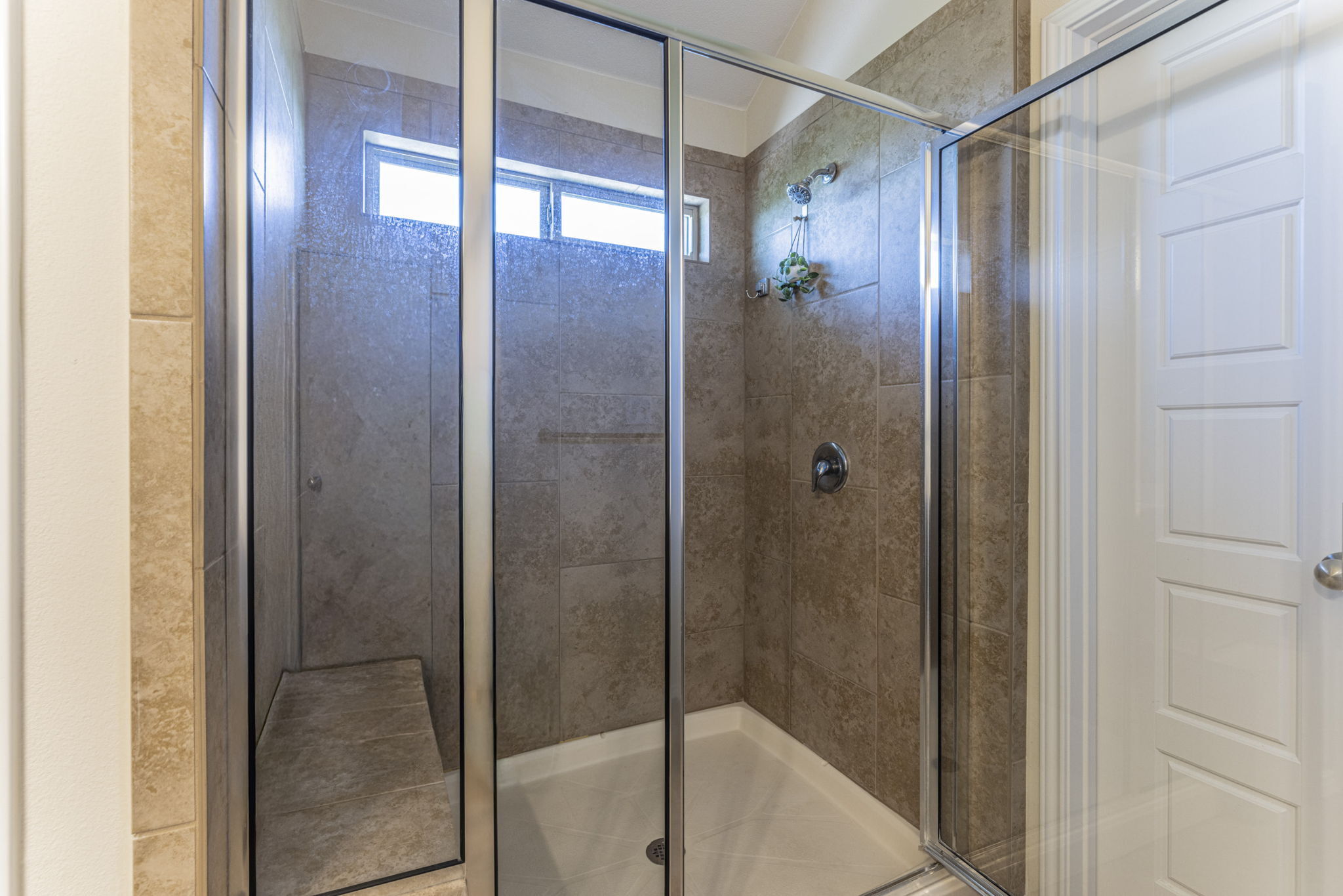 20205 Navarre Terrace Pflugerville, TX 78660 - Photo 14 of 24 a bathroom with a glass shower door