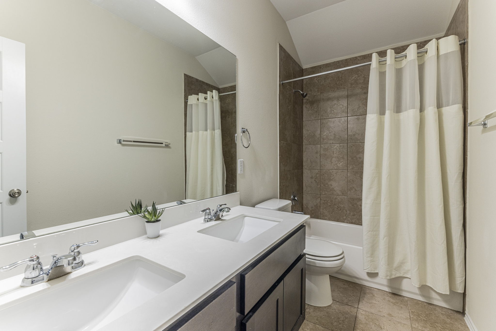 20205 Navarre Terrace Pflugerville, TX 78660 - Photo 18 of 24 a bathroom with a sink a toilet and shower