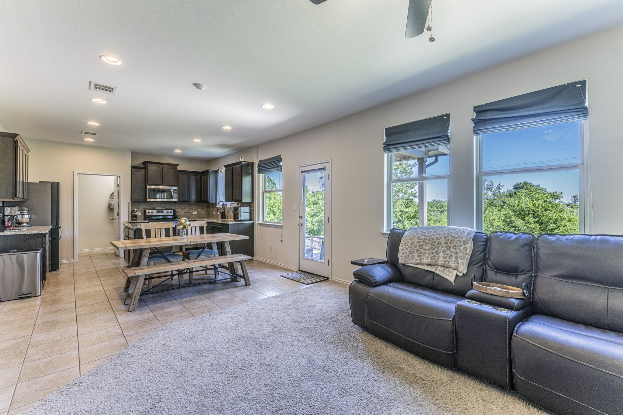 20205 Navarre Terrace Pflugerville, TX 78660 - Photo 2 of 24 a living room with furniture and a potted plant with wooden floor
