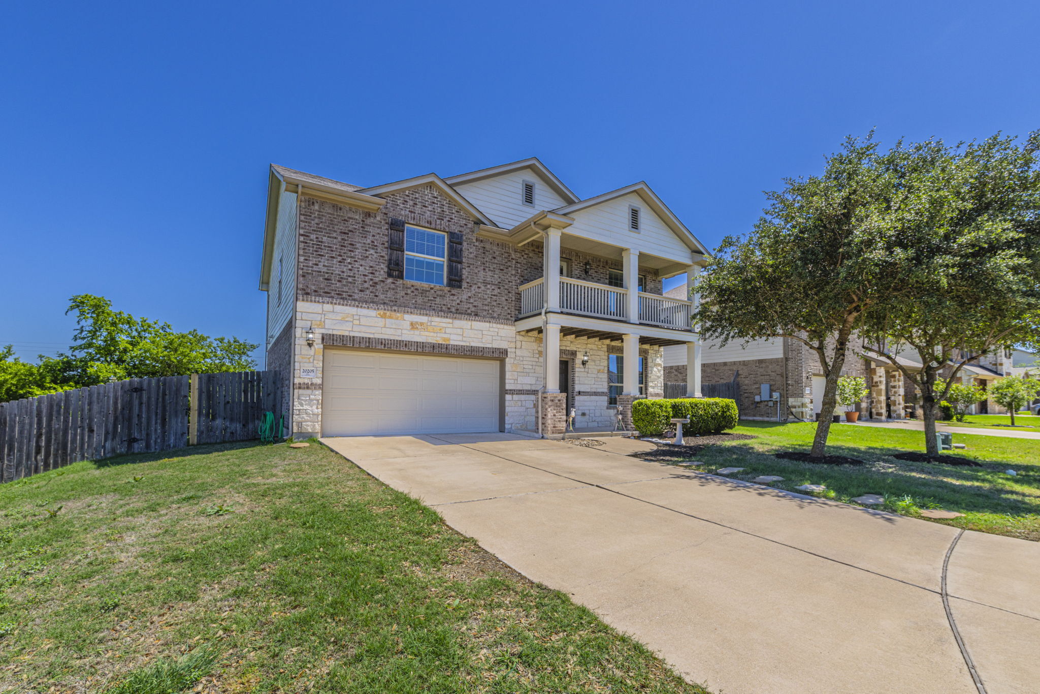 20205 Navarre Terrace Pflugerville, TX 78660 - Photo 22 of 24 a front view of a house with a yard and garage