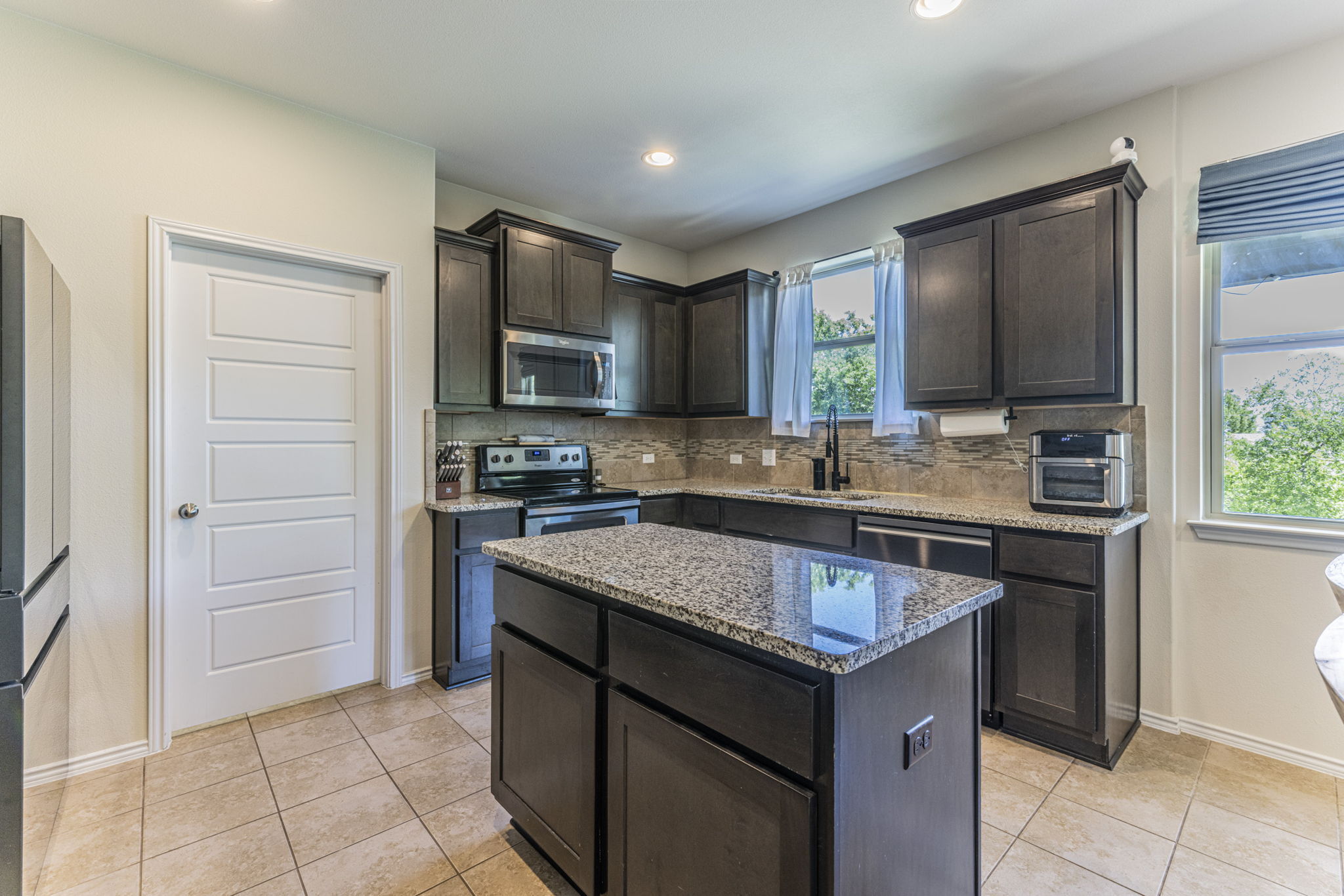 20205 Navarre Terrace Pflugerville, TX 78660 - Photo 6 of 24 a kitchen with a stove sink and cabinets