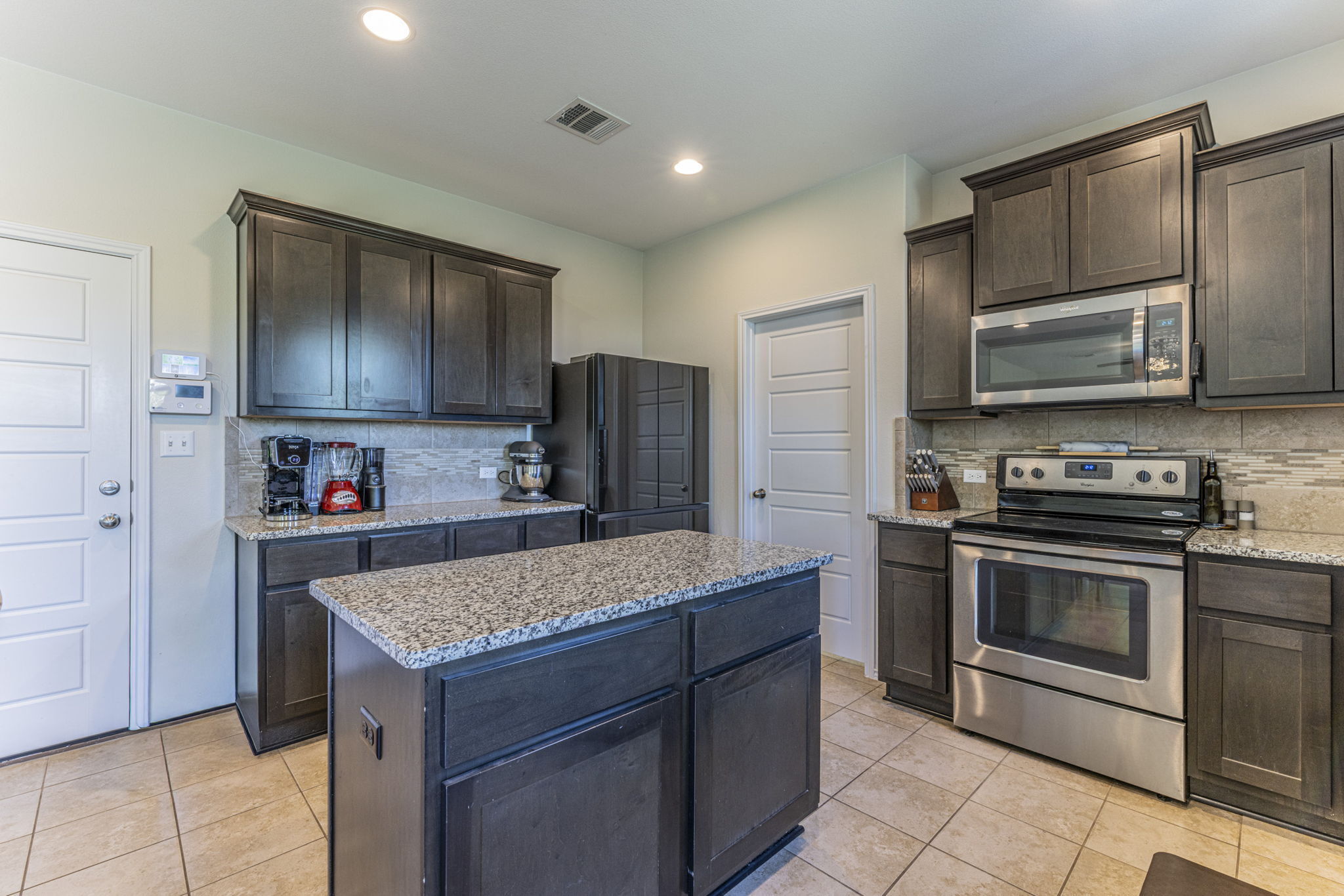 20205 Navarre Terrace Pflugerville, TX 78660 - Photo 7 of 24 a kitchen with a sink stove and refrigerator