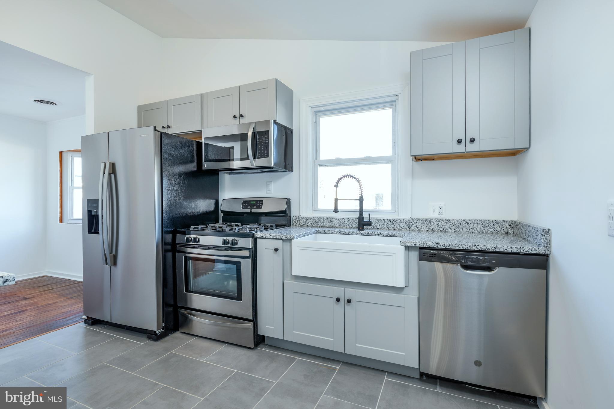 3005 Sollers Point Road Baltimore, MD 21222 - Photo 12 of 33 a kitchen with stainless steel appliances granite countertop a sink stove and refrigerator