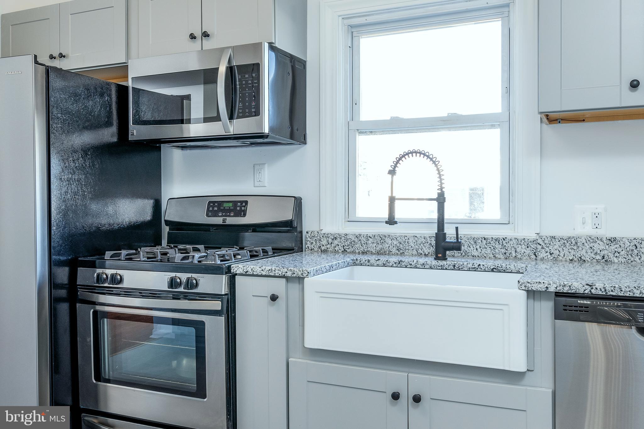 3005 Sollers Point Road Baltimore, MD 21222 - Photo 13 of 33 a kitchen with stainless steel appliances granite countertop a stove and a microwave