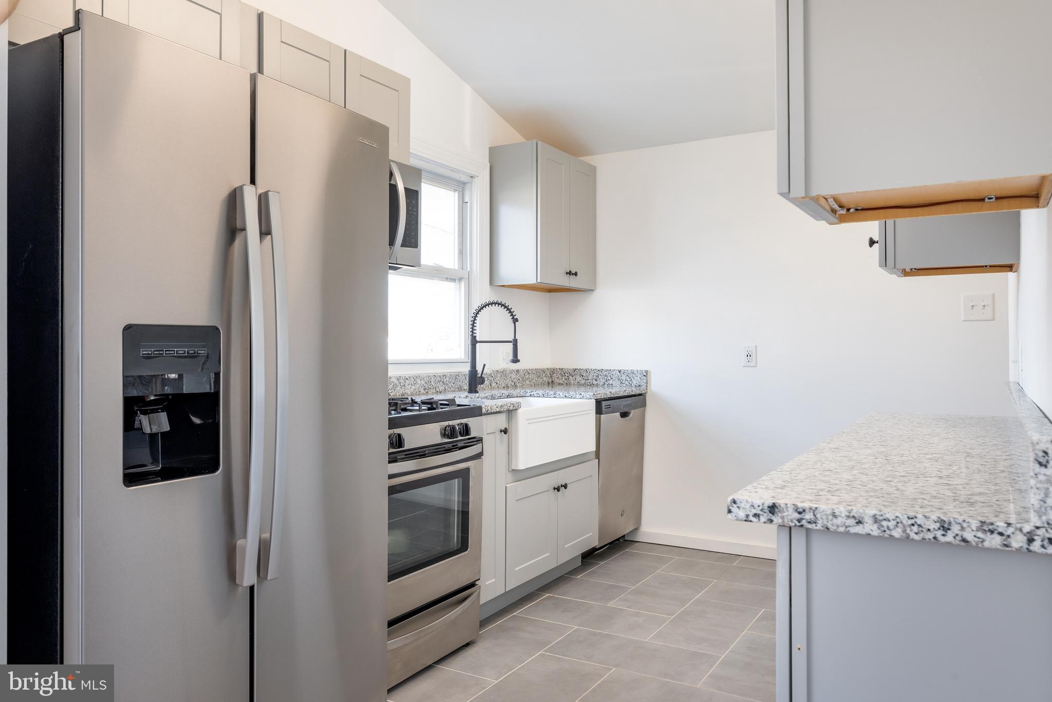 3005 Sollers Point Road Baltimore, MD 21222 - Photo 15 of 33 a kitchen with a sink stove and refrigerator