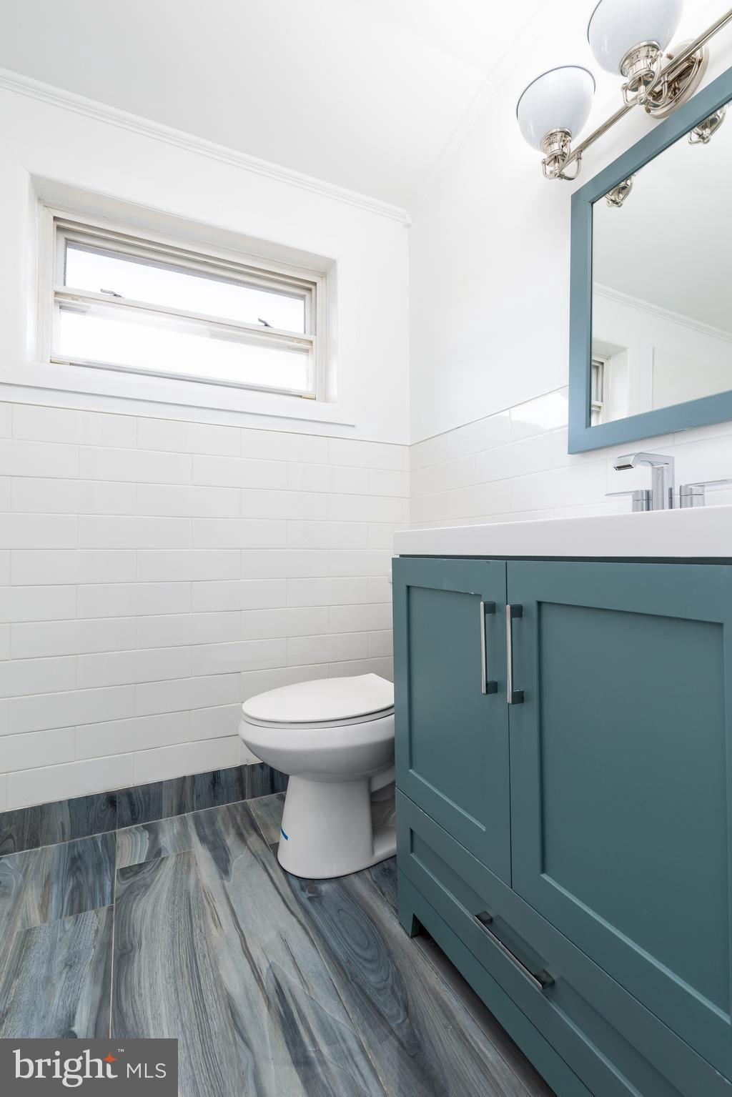 3005 Sollers Point Road Baltimore, MD 21222 - Photo 17 of 33 a bathroom with a toilet a sink and mirror