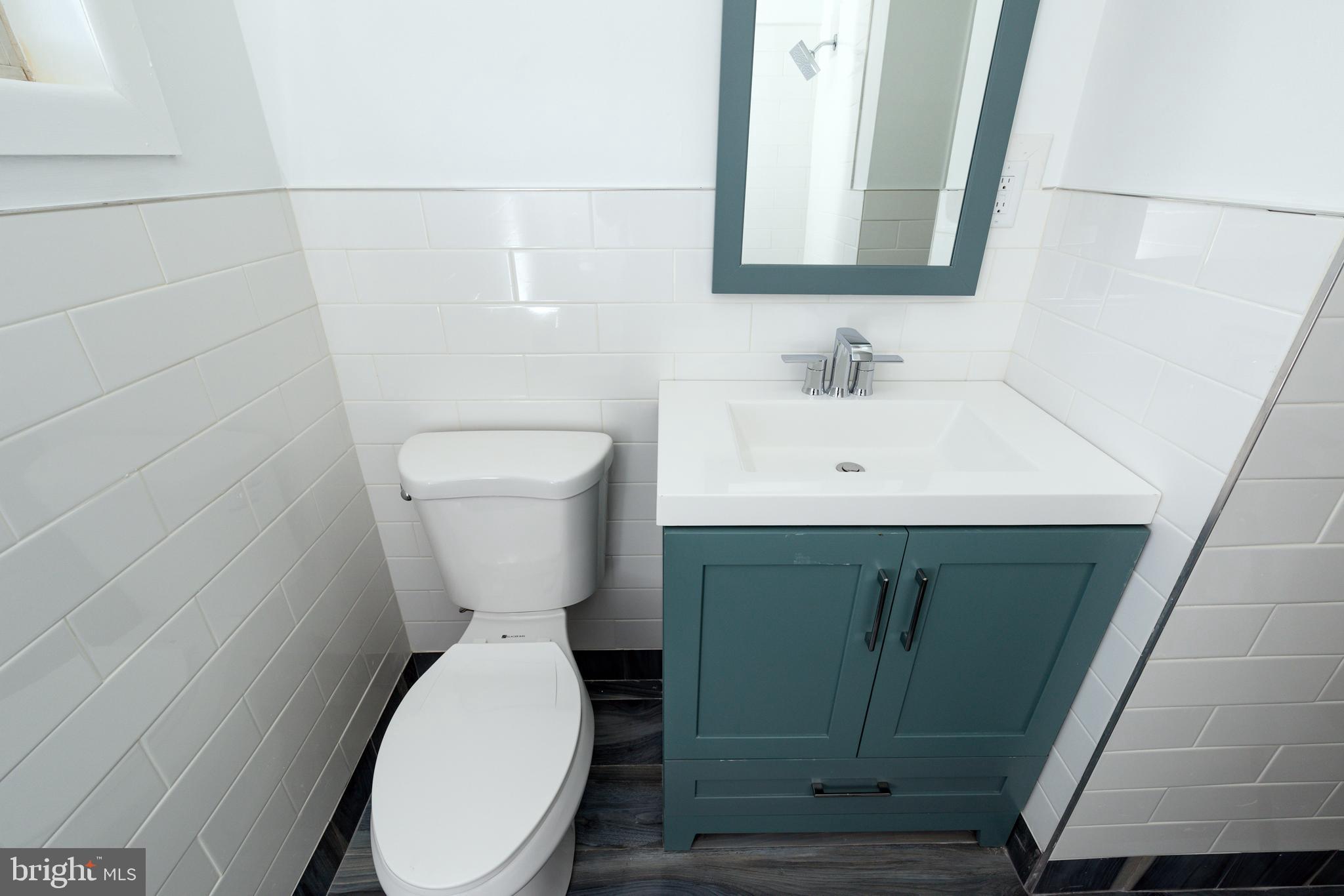 3005 Sollers Point Road Baltimore, MD 21222 - Photo 19 of 33 a bathroom with a toilet sink and mirror