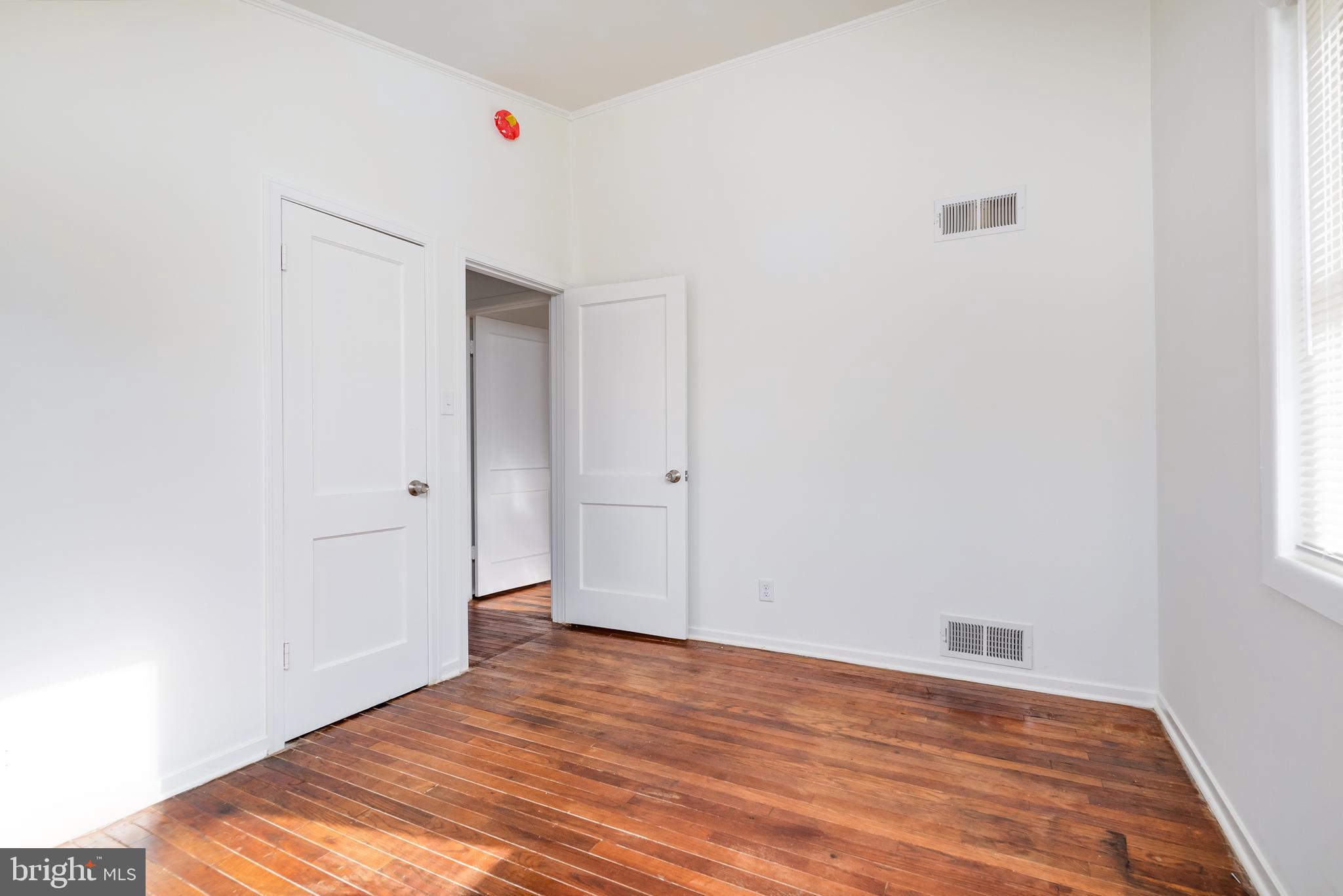 3005 Sollers Point Road Baltimore, MD 21222 - Photo 23 of 33 a view of empty room with wooden floor and fan