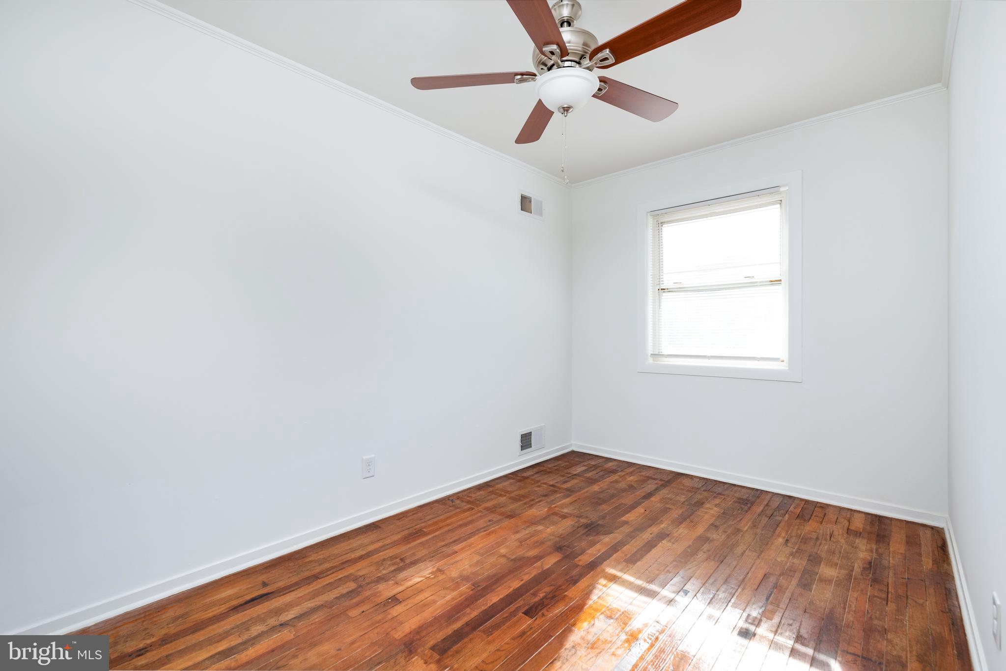 3005 Sollers Point Road Baltimore, MD 21222 - Photo 24 of 33 an empty room with a window and ceiling fan