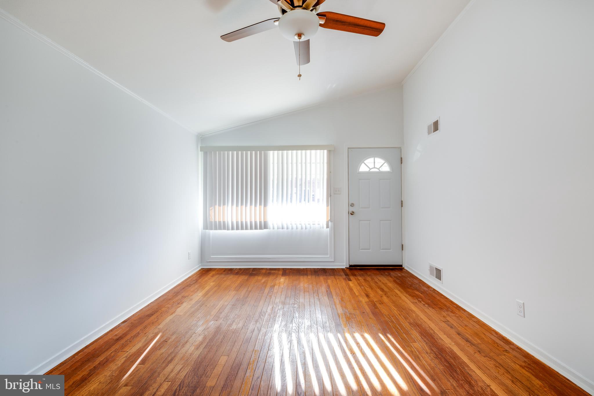 3005 Sollers Point Road Baltimore, MD 21222 - Photo 6 of 33 a view of empty room with wooden floor and fan