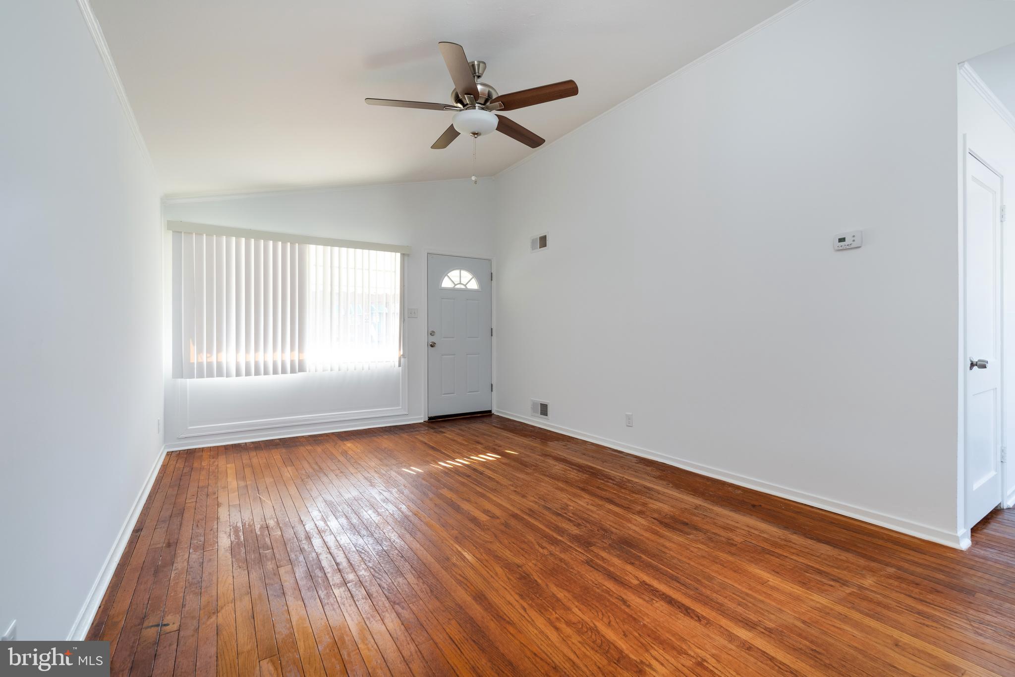 3005 Sollers Point Road Baltimore, MD 21222 - Photo 9 of 33 wooden floor in an empty room with a window