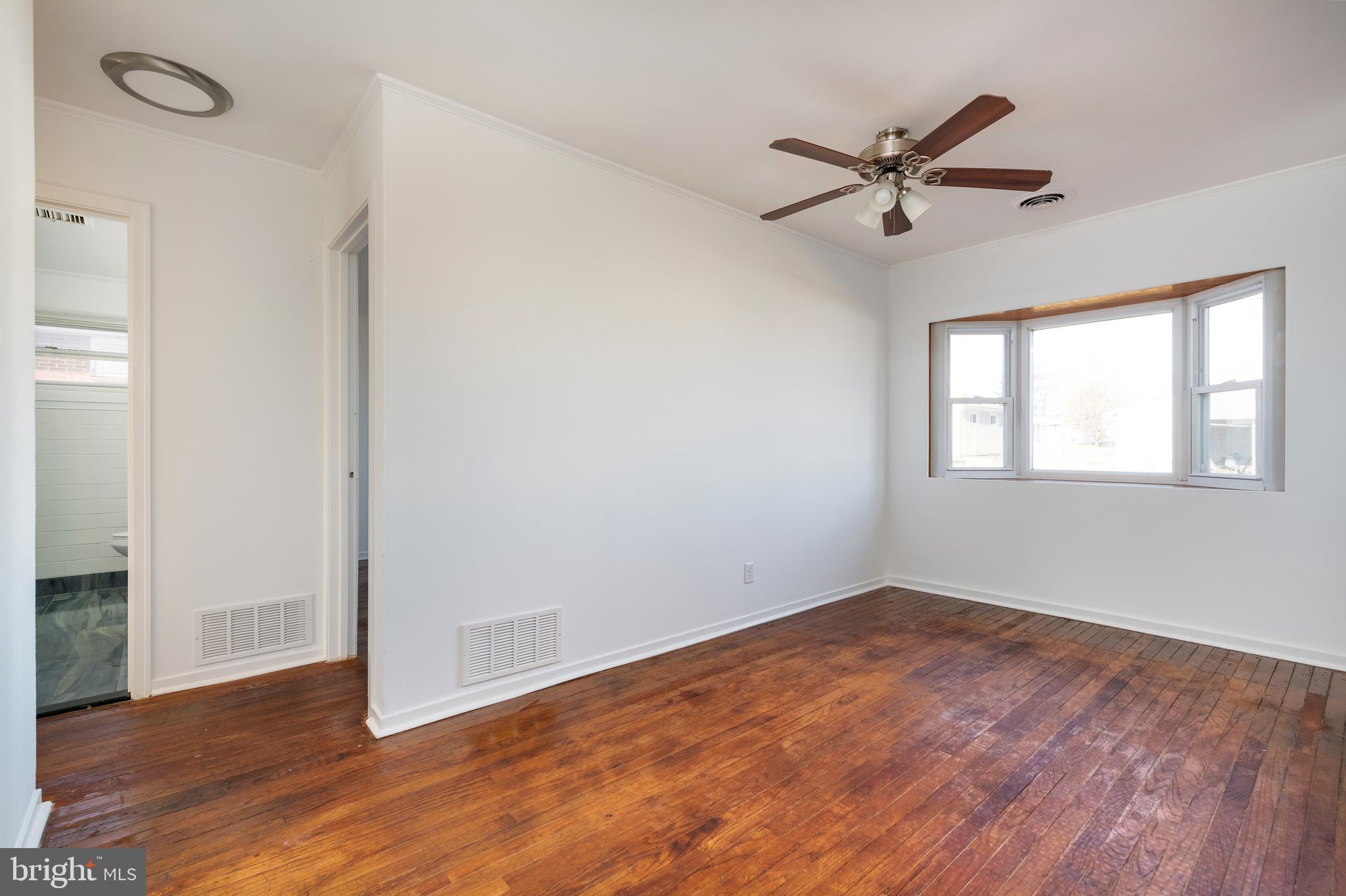 3005 Sollers Point Road Baltimore, MD 21222 - Photo 10 of 33 a view of a room with wooden floor closet and windows