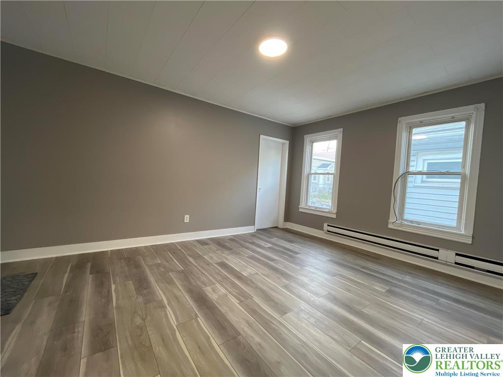 1222 Main Street, Unit 1 Northampton, PA 18067 - Photo 2 of 11 wooden floor in an empty room with a window