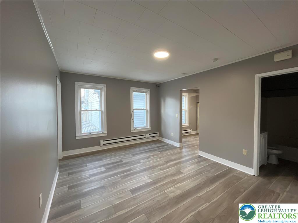 1222 Main Street, Unit 1 Northampton, PA 18067 - Photo 5 of 11 a view of an empty room with wooden floor and a window