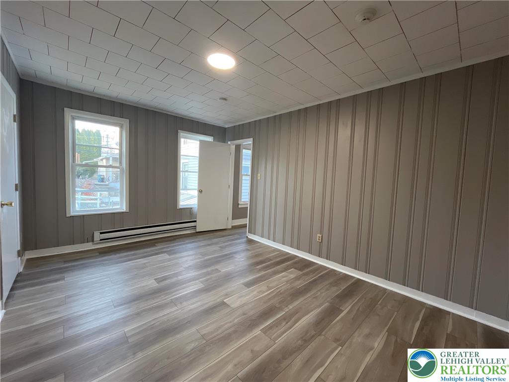 1222 Main Street, Unit 1 Northampton, PA 18067 - Photo 8 of 11 an empty room with wooden floor and windows