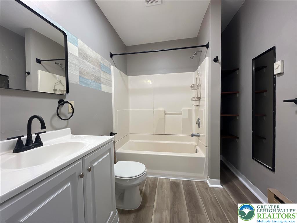 1222 Main Street, Unit 1 Northampton, PA 18067 - Photo 10 of 11 a bathroom with a sink a toilet and shower