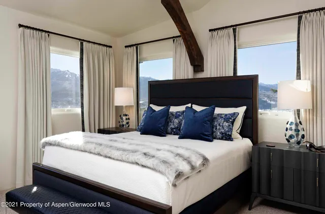 a bedroom with a large bed and a window