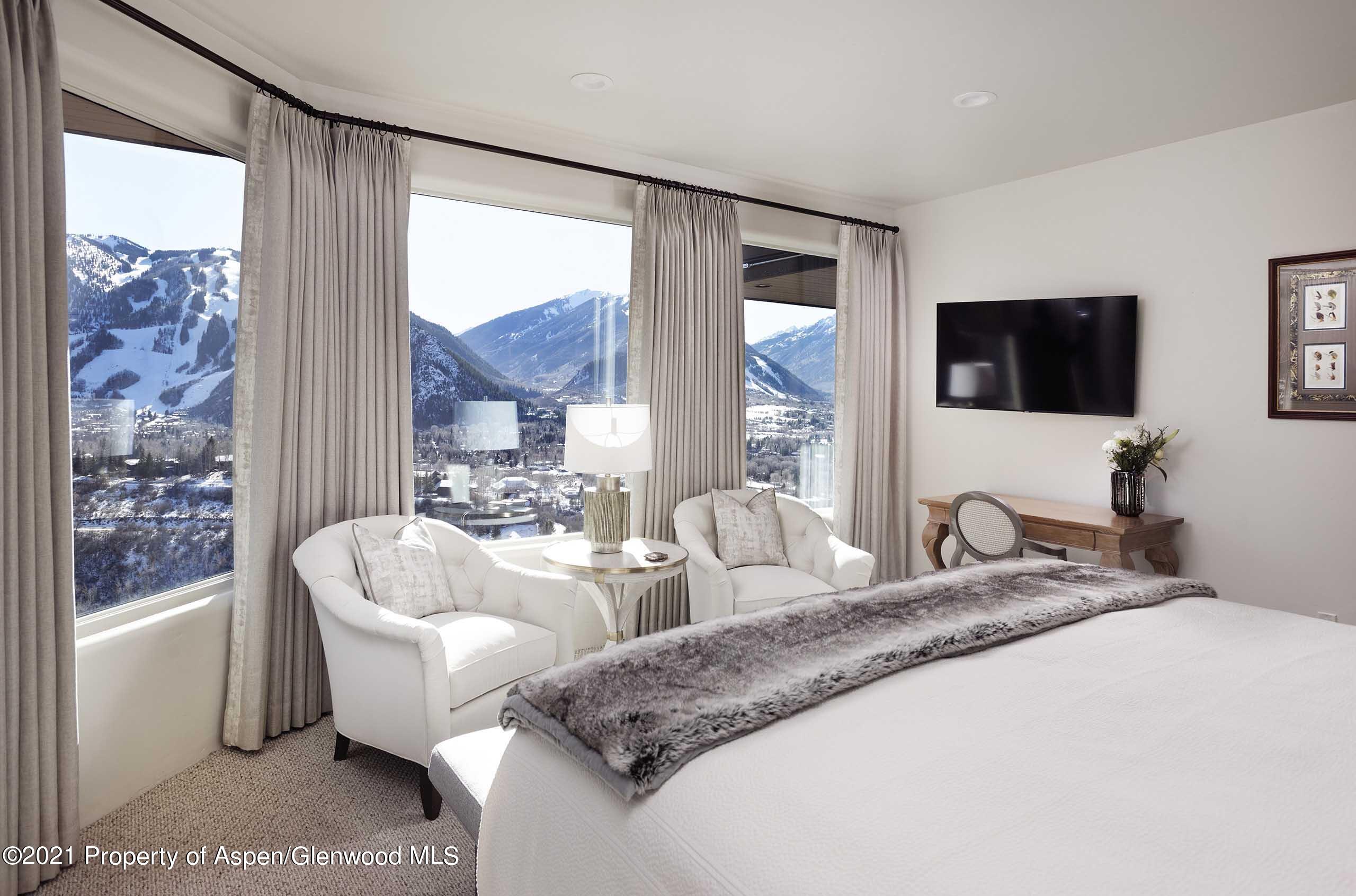 476 Wrights Road Aspen, CO 81612 - Photo 18 of 37 a spacious bedroom with a large bed and a flat screen tv