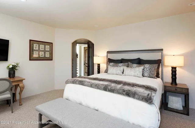 a bedroom with a bed and a table in it