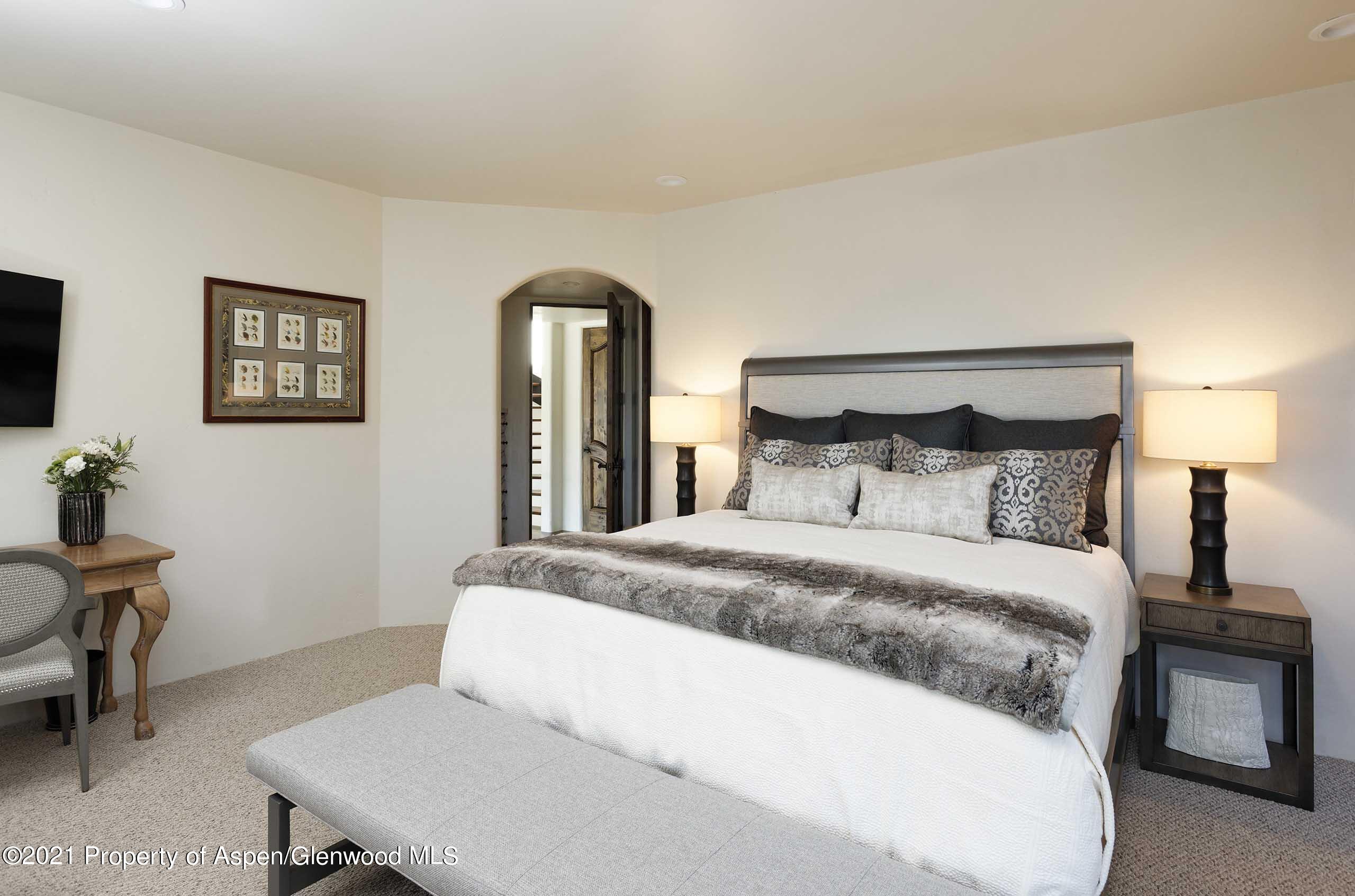 476 Wrights Road Aspen, CO 81612 - Photo 19 of 37 a bedroom with a bed and a table in it