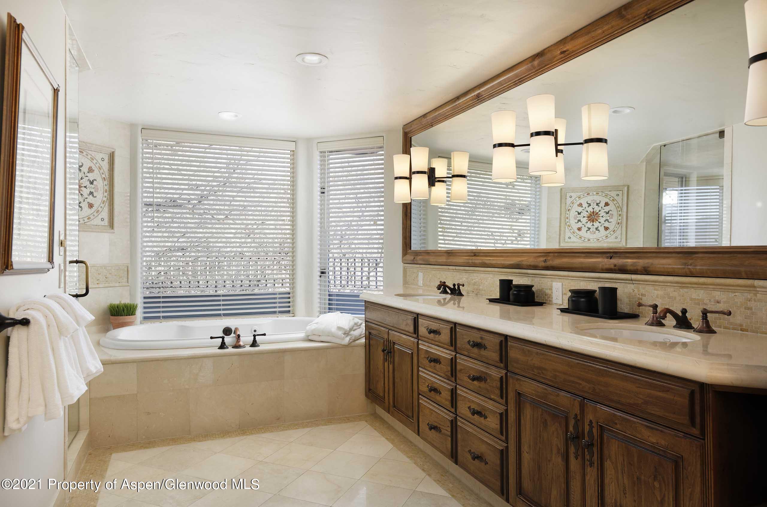 476 Wrights Road Aspen, CO 81612 - Photo 20 of 37 a bathroom with a tub a sink and a large mirror