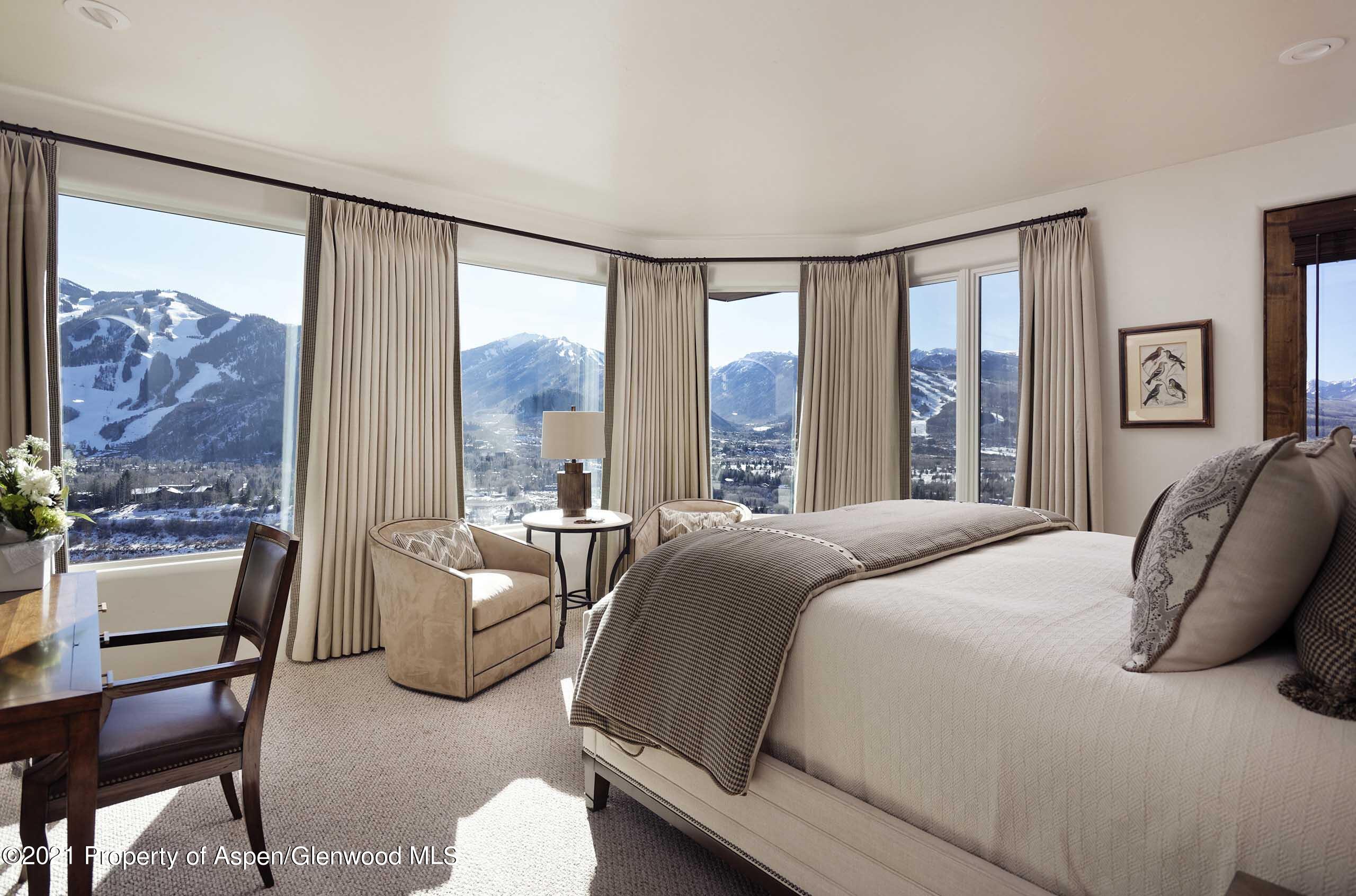 476 Wrights Road Aspen, CO 81612 - Photo 23 of 37 a bedroom with a bed and a large window