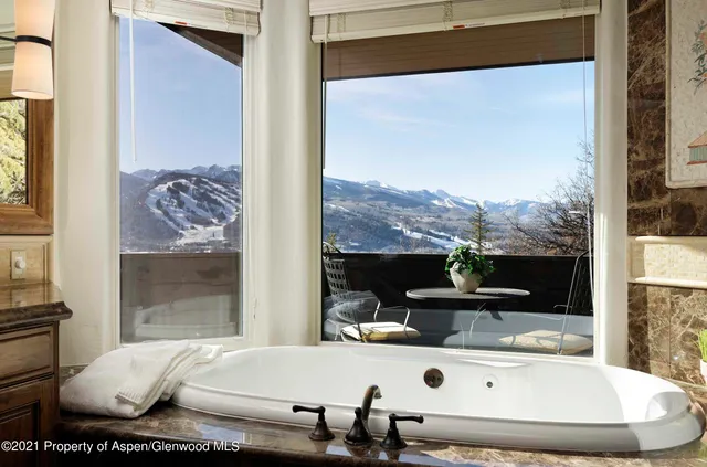 a living room with a large window and table