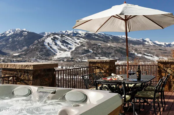 a view of a roof deck with furniture