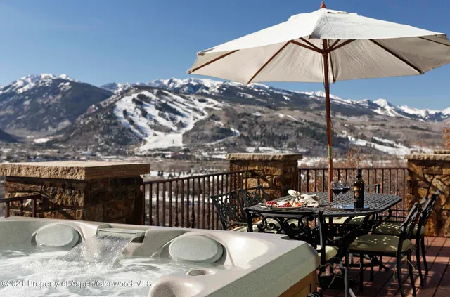 a view of a roof deck with furniture