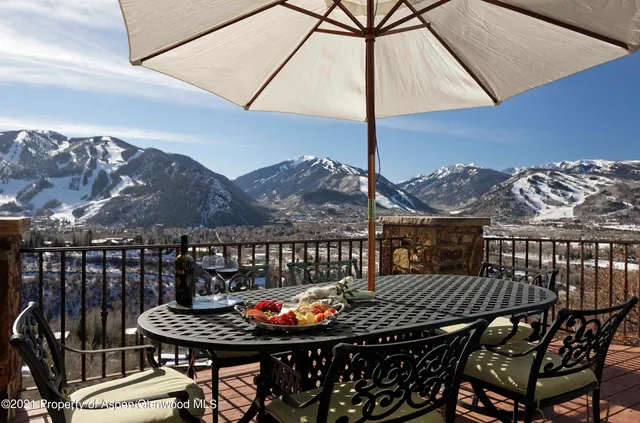 a balcony with table and chairs