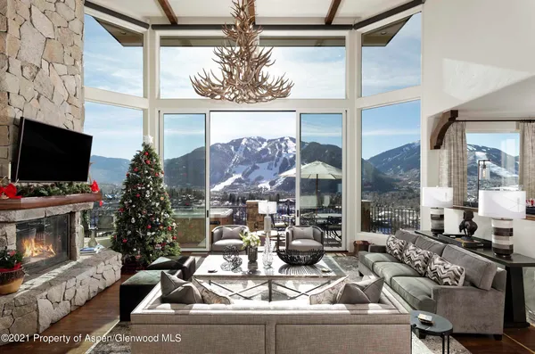 a view of a dining room with furniture a chandelier and wooden floor