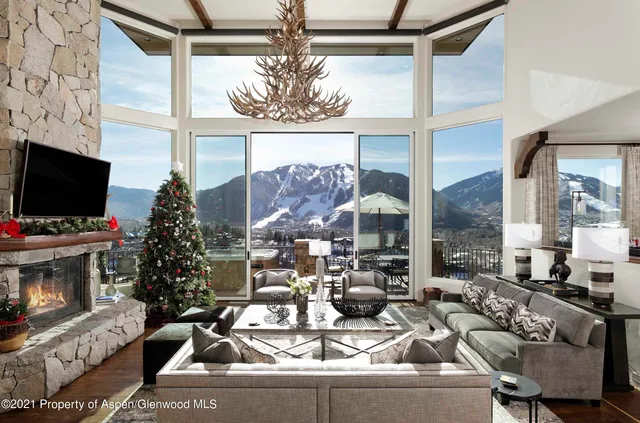 a view of a dining room with furniture a chandelier and wooden floor