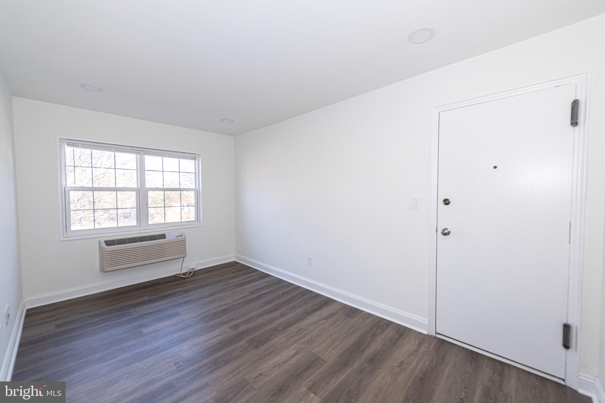 2237 Farrington Avenue, Unit 6204 Alexandria, VA 22303 - Photo 5 of 12 an empty room with wooden floor and windows