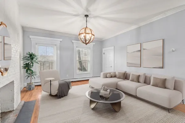 a living room with furniture potted plant and a chandelier