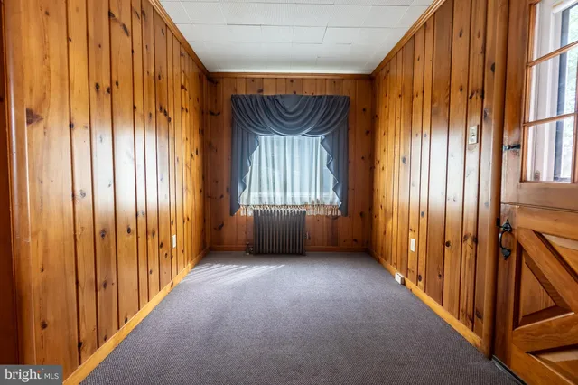 a view of a hallway with wooden shelves