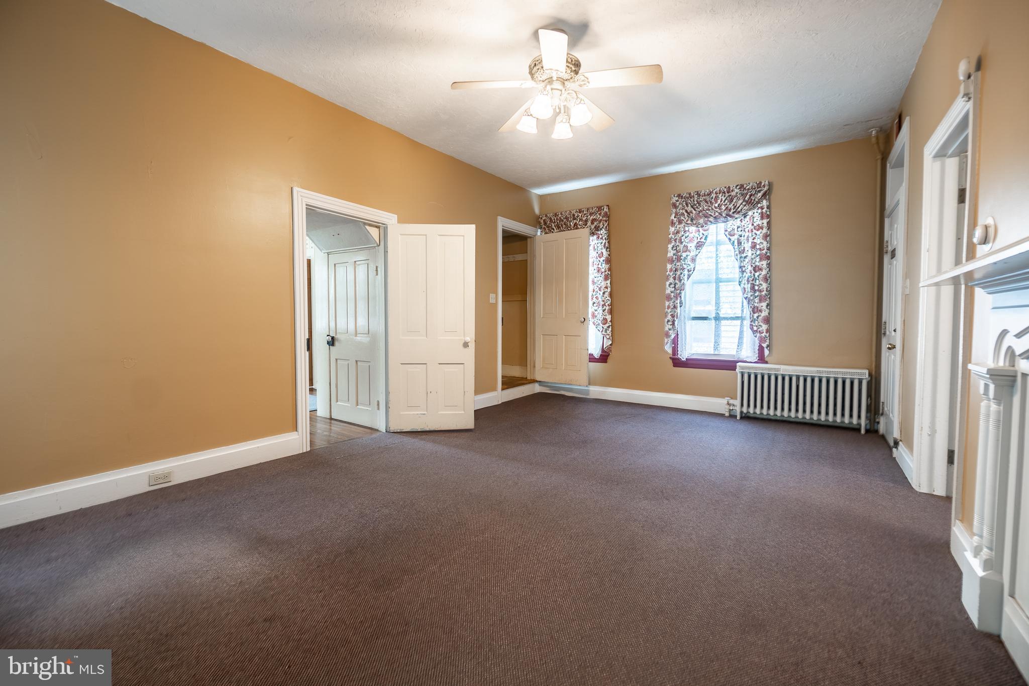 249 York Street Hanover, PA 17331 - Photo 14 of 42 an empty room with windows and ceiling fan