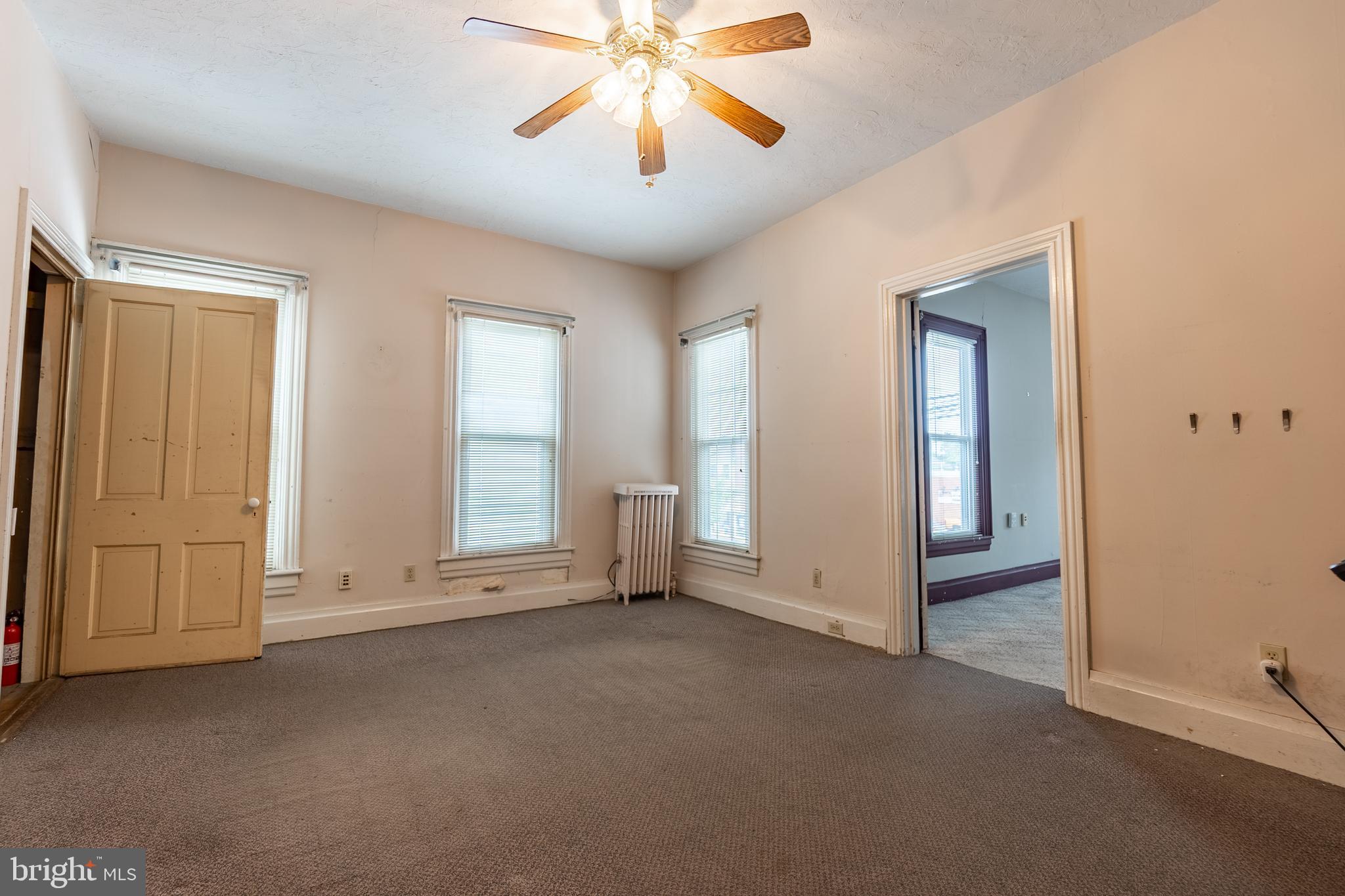 249 York Street Hanover, PA 17331 - Photo 24 of 42 an empty room with chandelier fan and windows