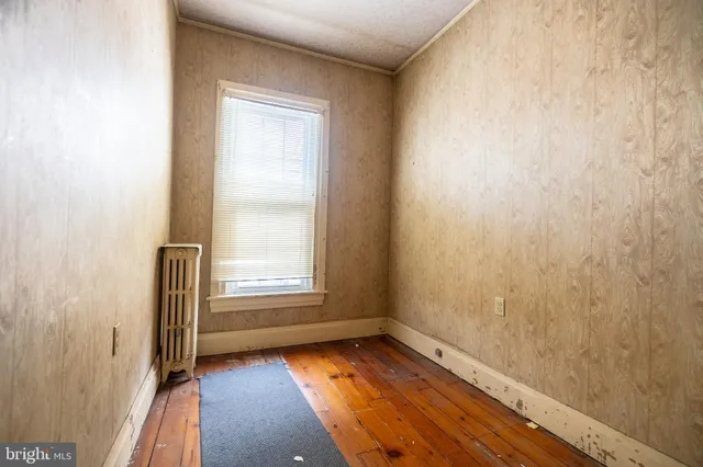 a white house with a large pool and couches chairs