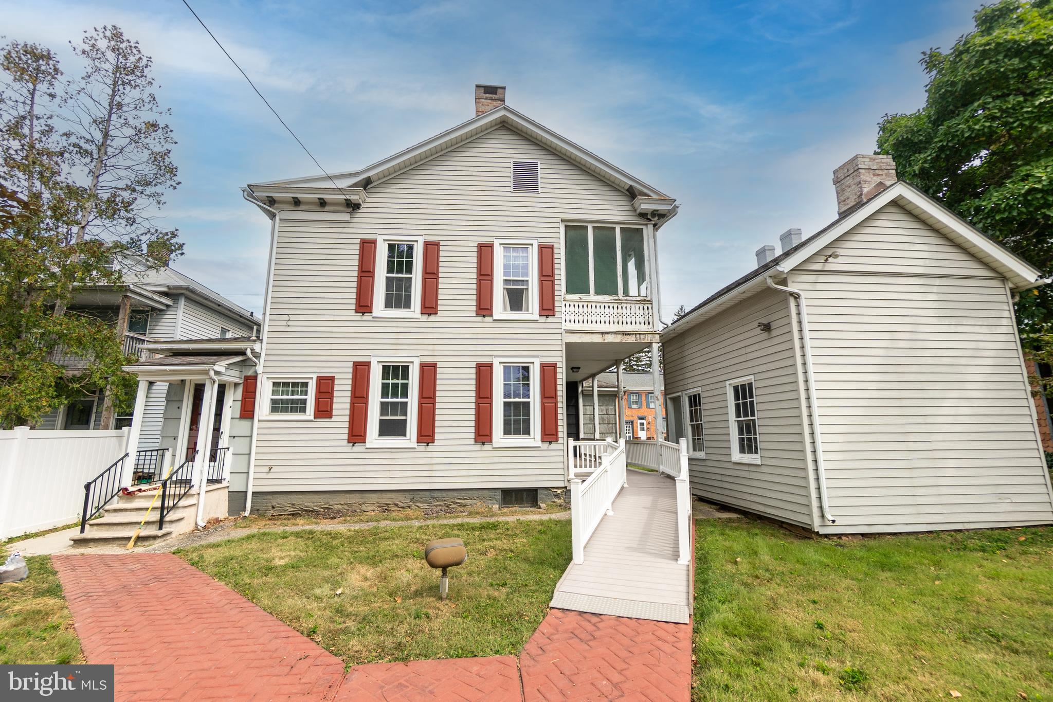 249 York Street Hanover, PA 17331 - Photo 37 of 42 a white house with a large pool and couches chairs