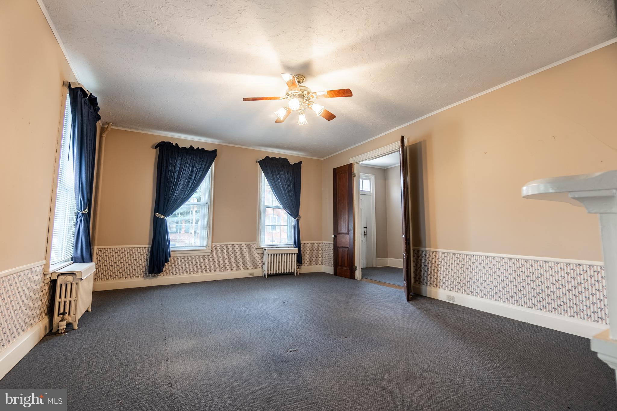 249 York Street Hanover, PA 17331 - Photo 8 of 42 an empty room with chandelier fan and windows