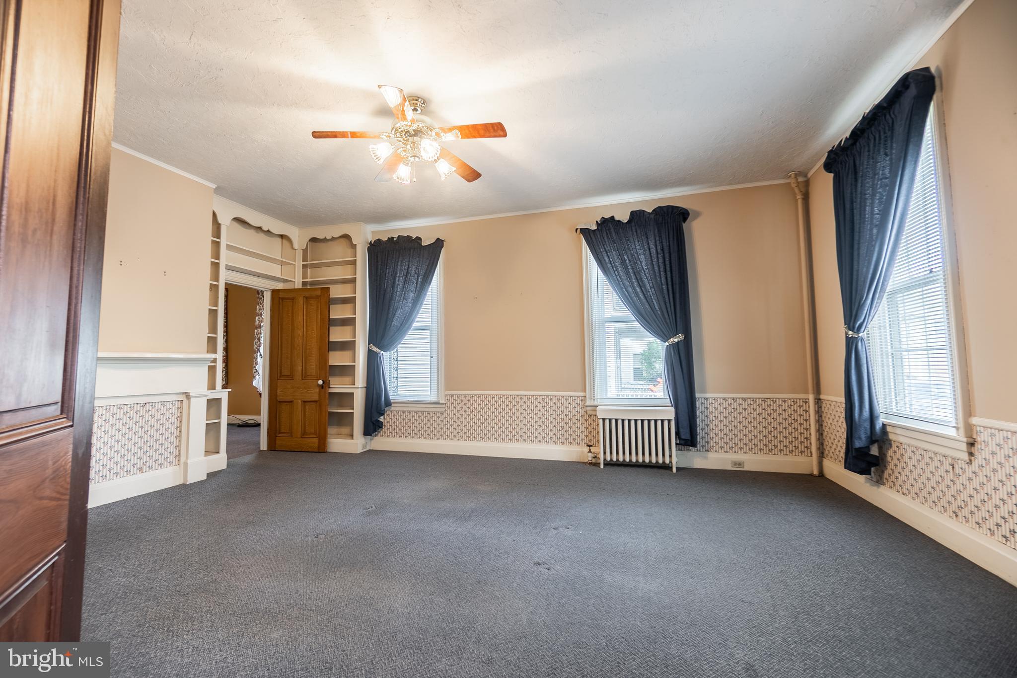 249 York Street Hanover, PA 17331 - Photo 9 of 42 a view of a livingroom with staircase ceiling fan and window