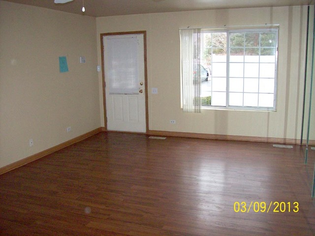 1402 Normantown Road Naperville, IL 60564 - Photo 2 of 11 an empty room with wooden floor and windows