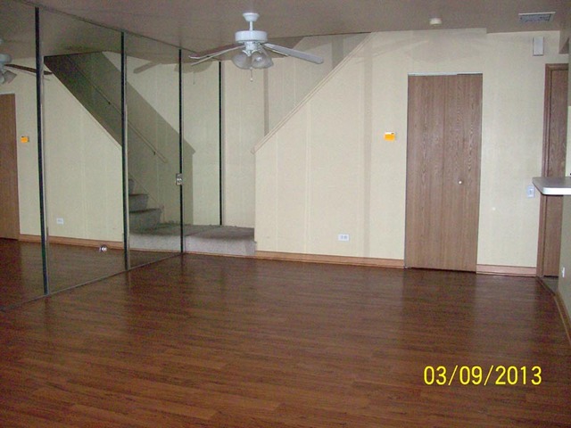 1402 Normantown Road Naperville, IL 60564 - Photo 3 of 11 an empty room with wooden floor and windows