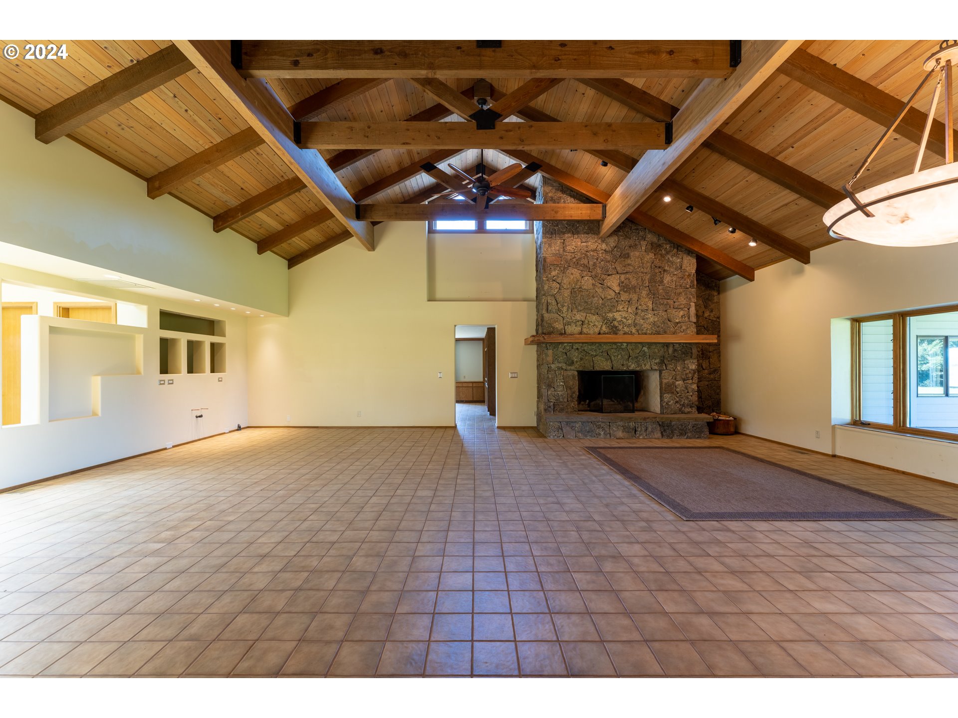 1488 Red Hill Road Oakland, OR 97462 - Photo 8 of 35 a view of an empty room with a fireplace and wooden floor