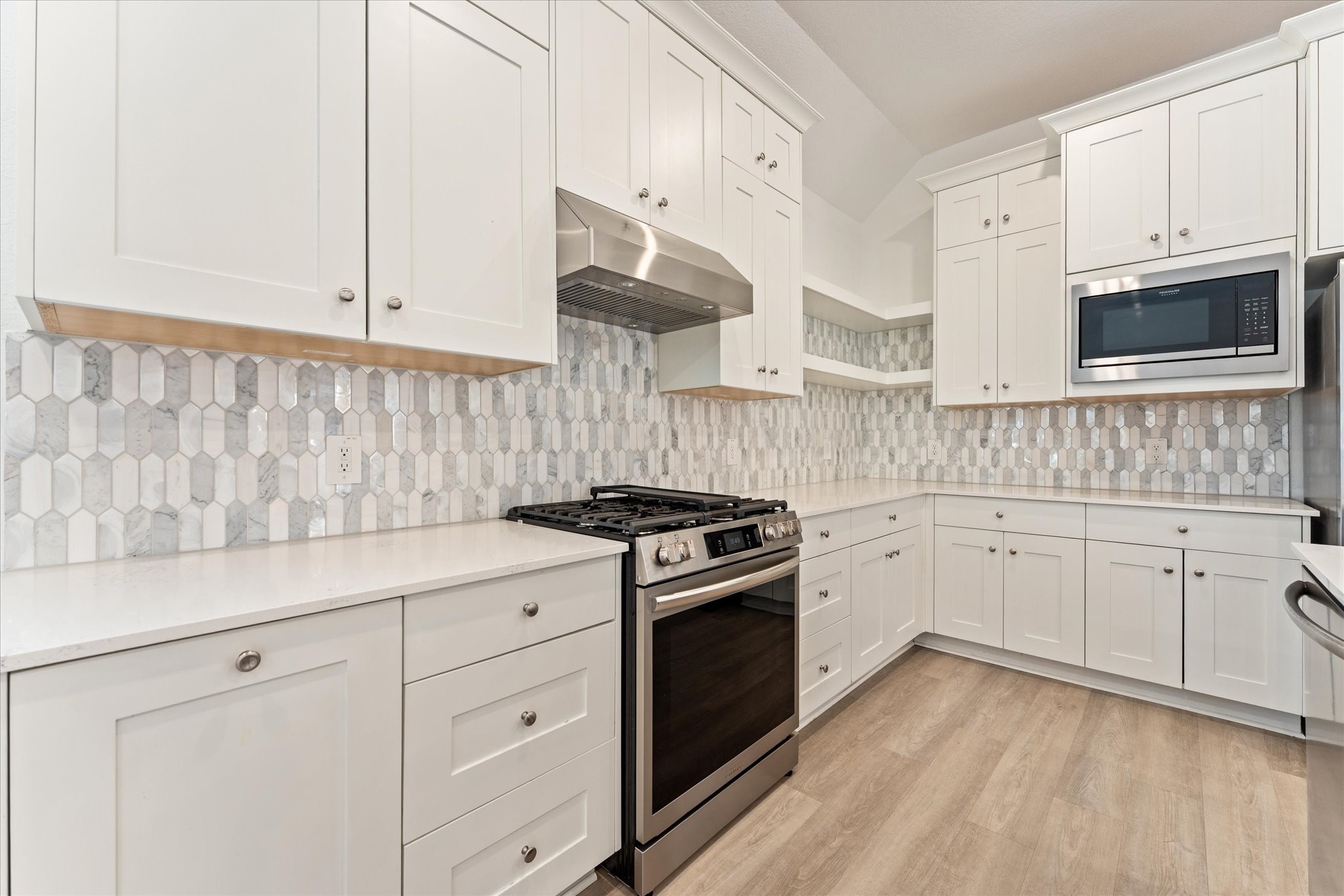 15520 Sunset Maple Court Conroe, TX 77302 - Photo 11 of 46 a kitchen with granite countertop white cabinets and stainless steel appliances