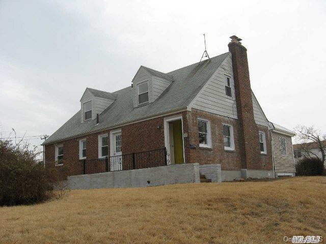 1334 Commodore Road Uniondale, NY 11553 - Photo 1 of 1 a front view of a house with a yard